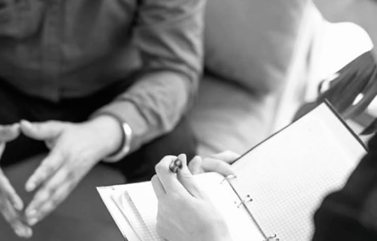 A therapist taking notes during a session